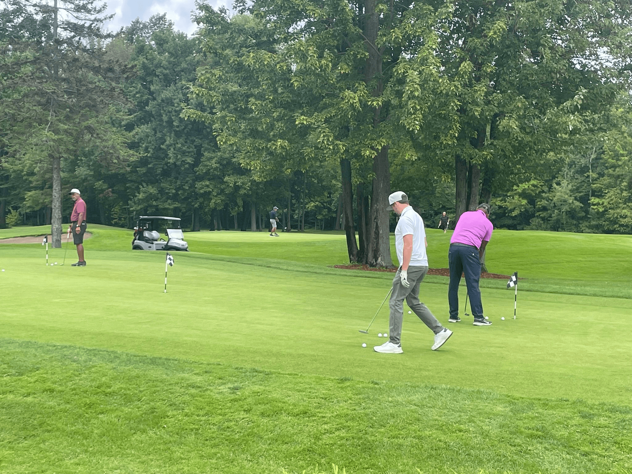 Golfers on the green at the inaugural One Love Golf Classic